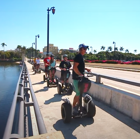 A family group out riding segways on an intercoastal walkway